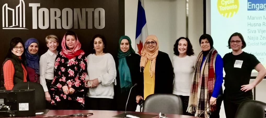 a diverse group of women standing side by side and smiling at the camera